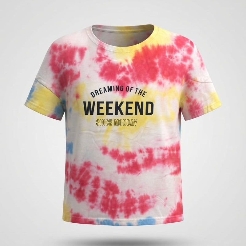 Kids tie-dye crop top with pink, yellow, and blue pattern, printed text "Dreaming of the Weekend Since Monday"